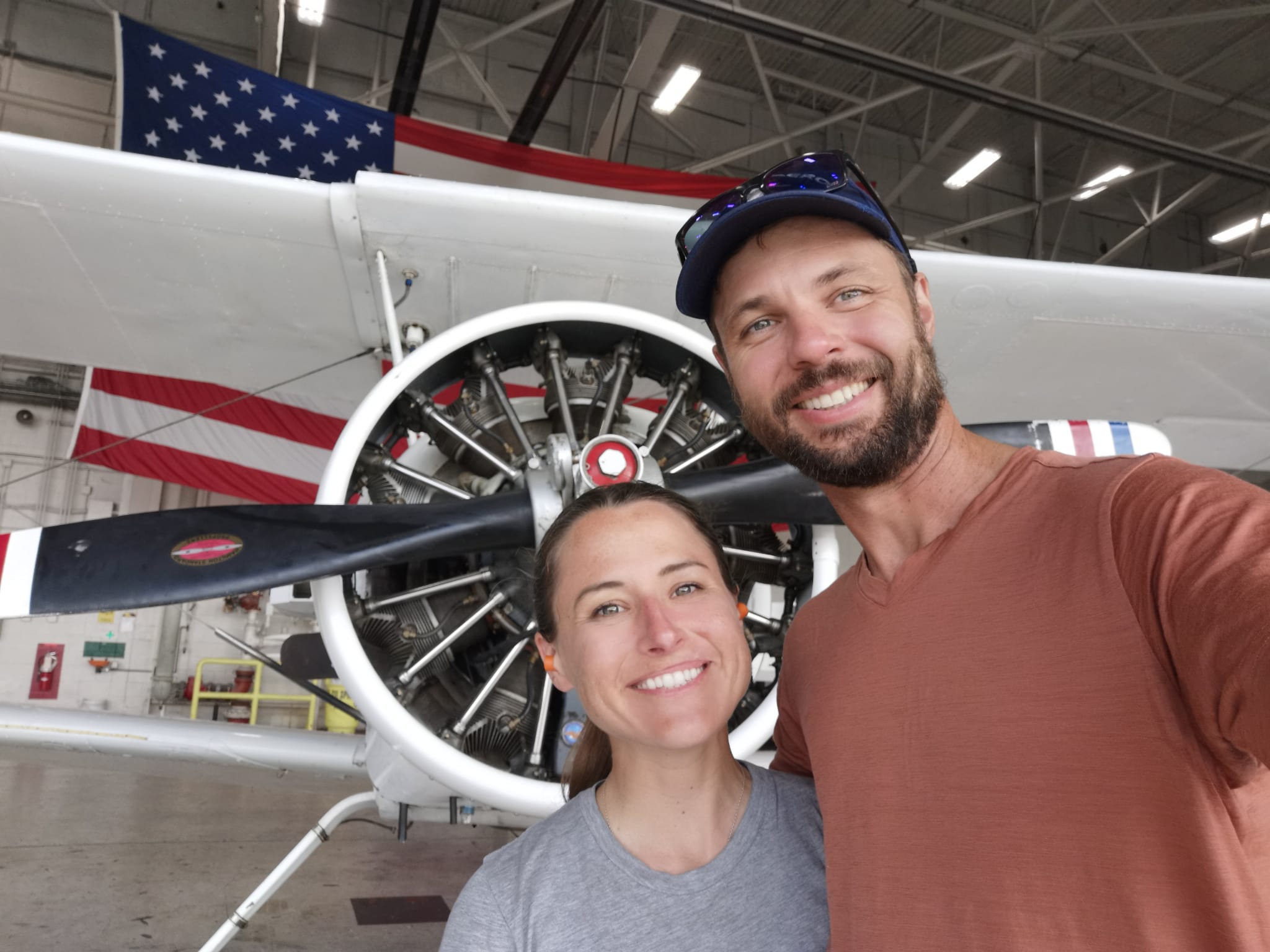 The Tryg Aviation crew in the hangar, with a radial engine and propeller behind them
